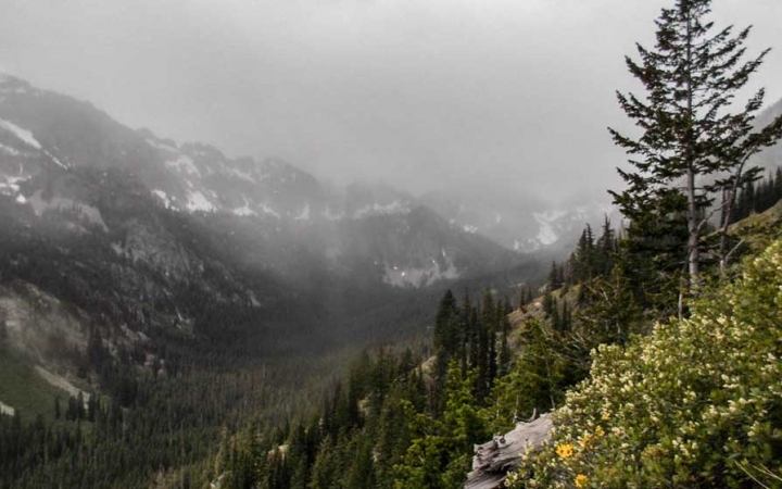 Rain, snow or fog distorts a mountainous valley.